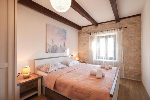 a bedroom with a large bed and a window at Villa Vita in Benkovac