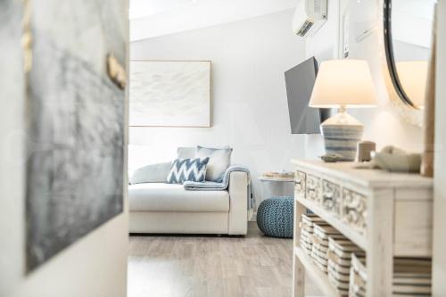 a living room with a white couch and a lamp at Coastal attic in the heart of Málaga by REMS in Málaga