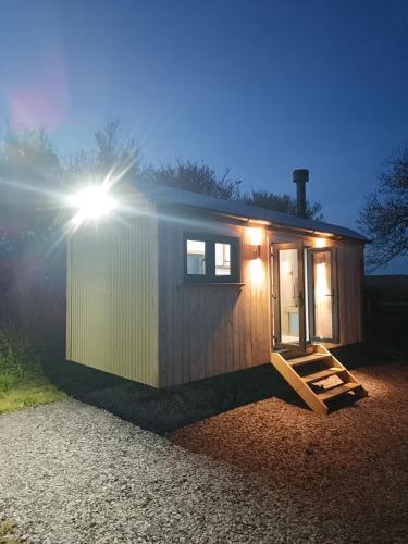 a tiny house with the sun shining on it at Old Quay Escape in Tenby