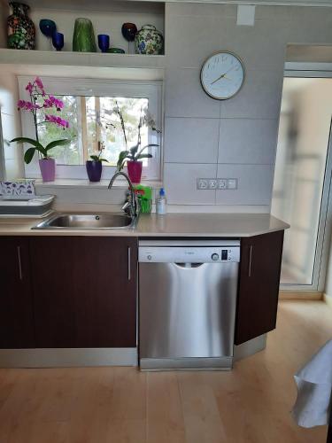 a kitchen with a stainless steel dishwasher and a sink at Jacqueline in Salou