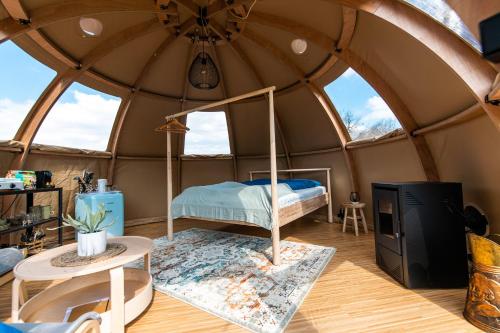 Vakantiepark Vinkenhof في سخين أوب خيو: غرفة نوم في خيمة قبة فيها سرير