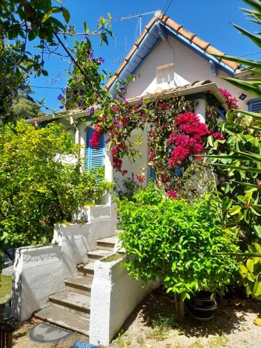 a house with flowers on the side of it at Au fil de l eau in Cannes