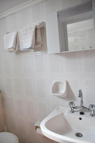 a bathroom with a sink and a toilet and a mirror at Seaside 2 in Kómboi