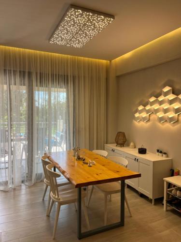 una sala da pranzo con tavolo e sedie in legno di Nikiti Heart Luxury Villa a Nikiti