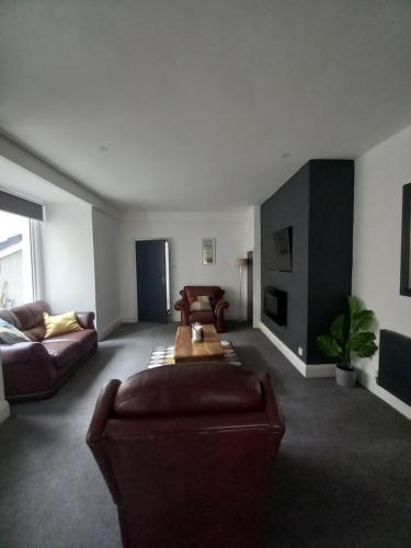 a living room with a couch and a table at NO 27 Apartment in Llandudno