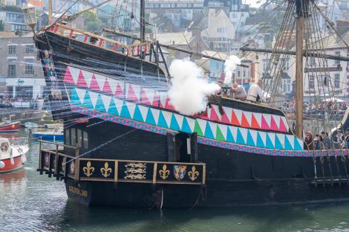 a pirate ship is docked in the water at HORTUS HOUSE - Regency style apartment with attached parking in Brixham
