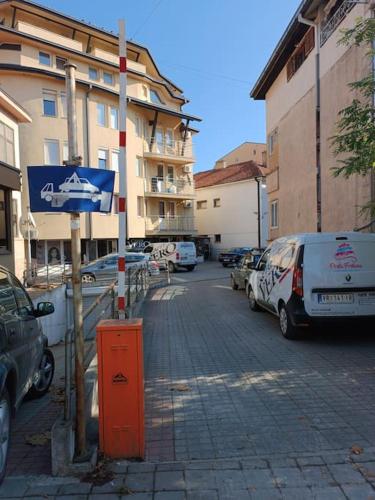 a street with cars parked in a parking lot at Vranje City Center, Penthouse Delux Apartment in Vranje