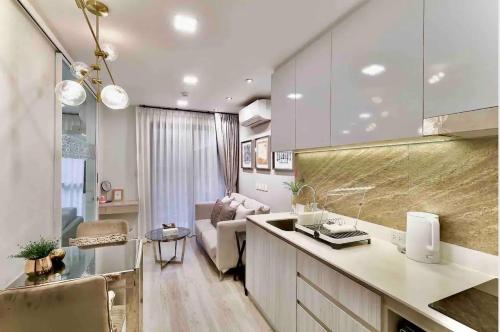 a kitchen and living room with a counter and a couch at Huahin Stay in Hua Hin