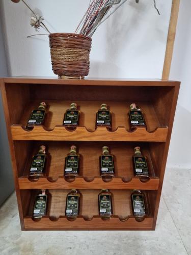 a shelf filled with lots of bottles on top at Hotel Domino in Gjirokastër