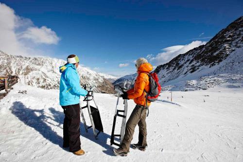 two people standing on top of a snow covered mountain at Piccolo Hotel Gurschler in Maso Corto
