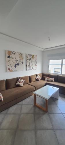 a living room with a couch and a coffee table at La perla blanca in M'diq