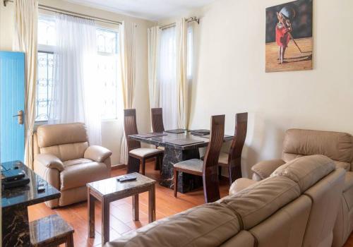 a living room with a couch and a table at 2 bedroom entire Apt Fully air conditioned-MSA City centre in Mombasa
