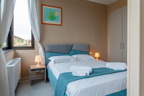 um quarto com uma cama azul com toalhas em Sole Apartment em Turim