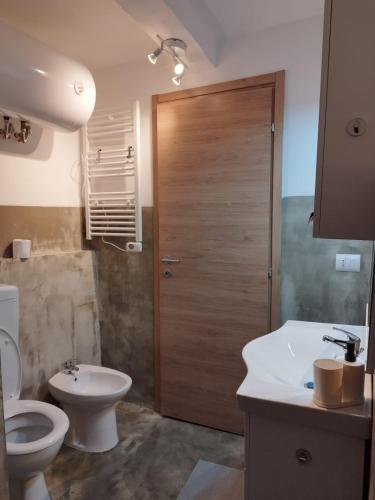 a bathroom with a toilet and a sink and a shower at The First Luccoli Garibaldi Rolli in Genova