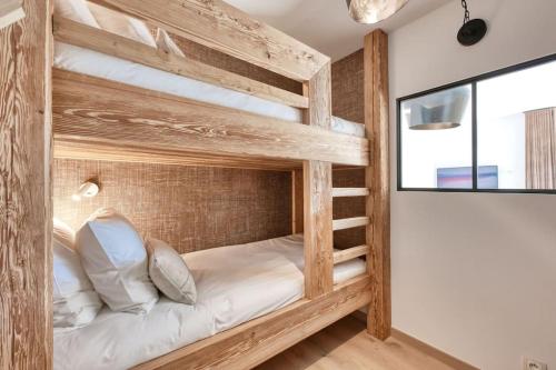 two bunk beds in a room with a window at La Collection - Le Village in Saint-Gervais-les-Bains