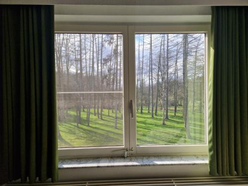 an open window with a view of a yard at Villa Op de Voort (XL, 12-22 personen) in Heusden - Zolder