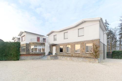 a large white house with a driveway at Villa Op de Voort (XL, 12-22 personen) in Heusden - Zolder