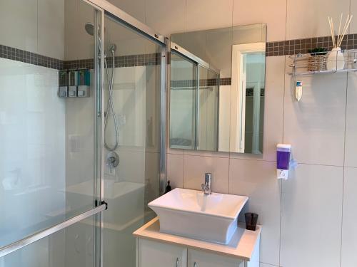 a bathroom with a sink and a shower at Comfy place with all in Revesby