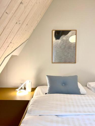 a bedroom with a bed with a blue pillow at Herberg Swaen aan de Brink in Den Ham