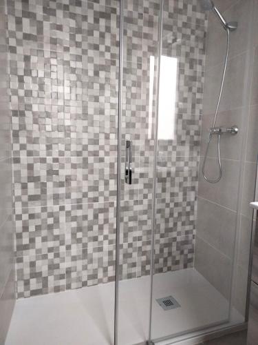 a shower with a glass door in a bathroom at MARiPEP Playa Vinaròs in Vinarós