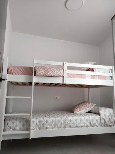 a bunk bed room with two bunk beds at MARiPEP Playa Vinaròs in Vinarós