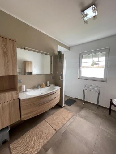 a bathroom with a sink and a large mirror at Apartment Katharina in Klagenfurt