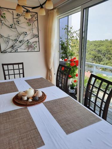 a dining room with two tables and a balcony at Jacqueline in Salou