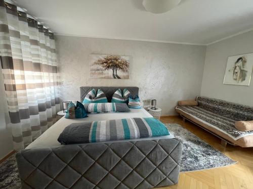 a bedroom with a large bed and a couch at Apartment Katharina in Klagenfurt