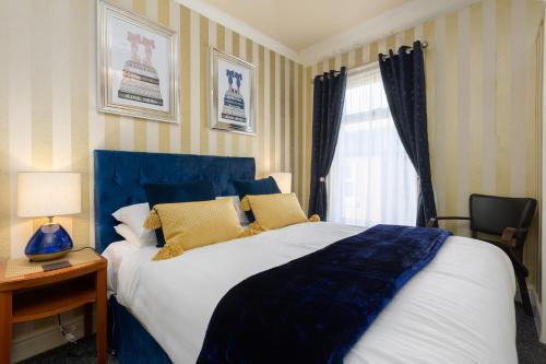 a bedroom with a large bed and a window at Adelaide Lodge - Town Centre - Opposite Winter Gardens in Blackpool