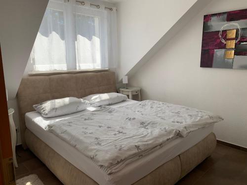 a bed with two pillows in a bedroom at Appartment Strandstraße 29 Wohnung Nr. 16 in Trassenheide