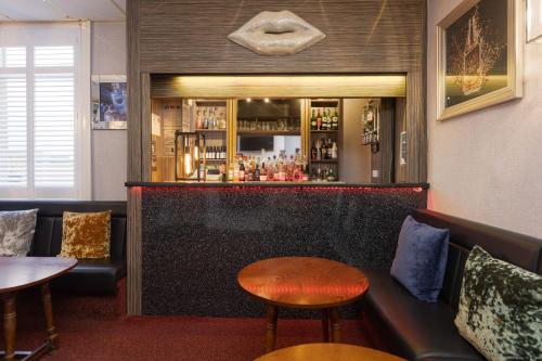a bar with a bench and a table and chairs at Adelaide Lodge - Town Centre - Opposite Winter Gardens in Blackpool