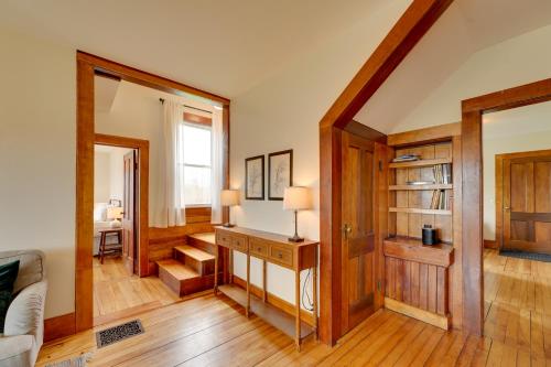 a living room with wooden floors and a staircase at 17-Acre Vermont Escape with Panoramic Mountain Views in Cavendish