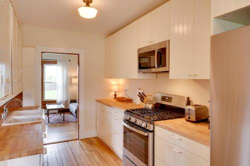 a kitchen with white cabinets and a stove top oven at 17-Acre Vermont Escape with Panoramic Mountain Views in Cavendish