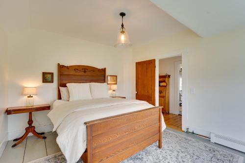 a bedroom with a large bed and a table at 17-Acre Vermont Escape with Panoramic Mountain Views in Cavendish