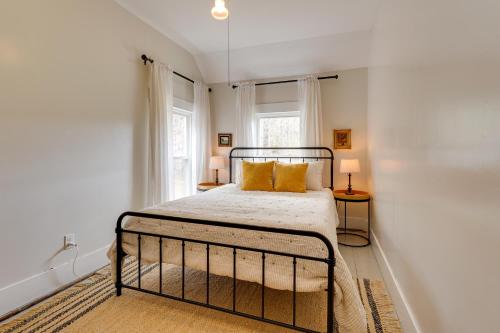 a bedroom with a bed and two windows at 17-Acre Vermont Escape with Panoramic Mountain Views in Cavendish