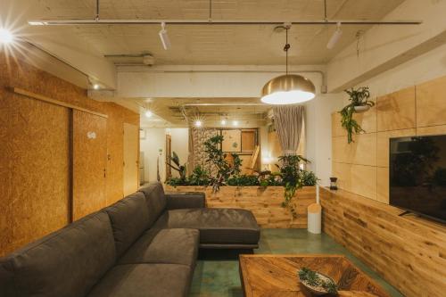 a living room with a couch and a table at DENCHI TOKYO - Private Designer Stay in Asakusa in Tokyo