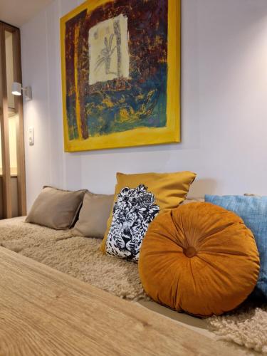 a bed with a large orange pillow on top of it at Villa Op de Voort (XL, 12-22 personen) in Heusden - Zolder