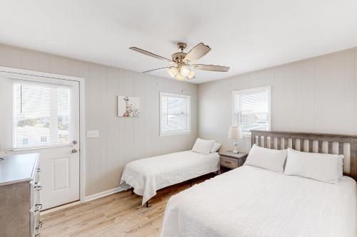 a bedroom with two beds and a ceiling fan at HB261 Rosie's Rendezvous in Holden Beach