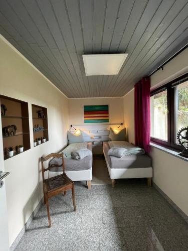 a living room with a couch and a chair at FeWo Eilers in Schönau-Berzdorf