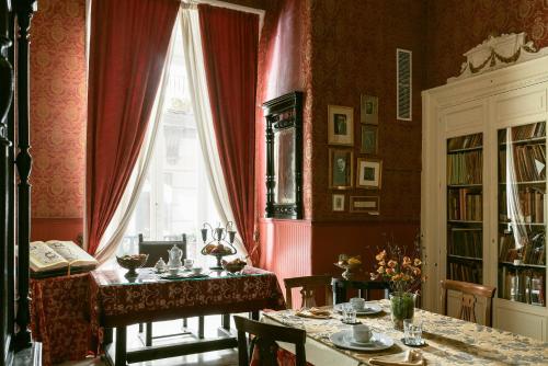 a dining room with a table and a window at Carafa di Maddaloni Residenza di Charme in Naples