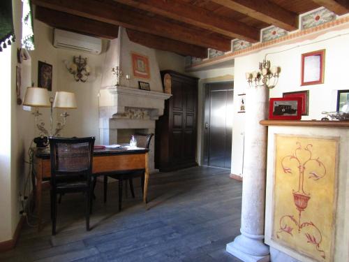a dining room with a table and a fireplace at Antichi Feudi Dimora D'Epoca in Teggiano