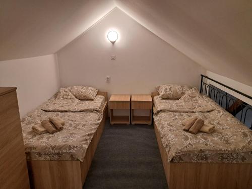 a room with two beds and a desk in it at Daka in Vrnjačka Banja