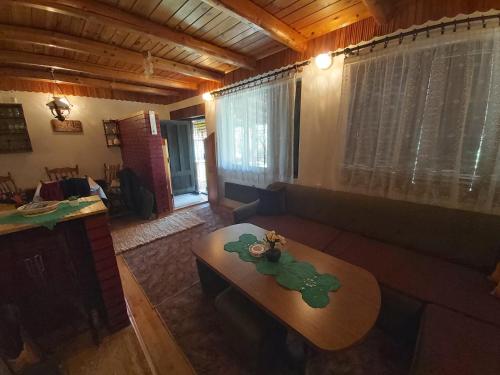 a living room with a table and a couch at Vikendica odmor za dusu in Visoko