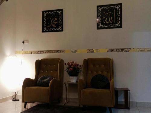 two chairs and a table in a waiting room at MY KIJANG HOMESTAY - Banglo, Alor Setar Kedah DarulAman in Alor Setar