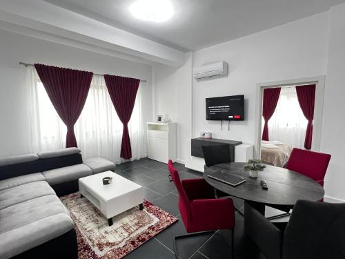 a living room with a couch and a table at Marvellous Aparthotel with Master Apartments Suceava in Suceava