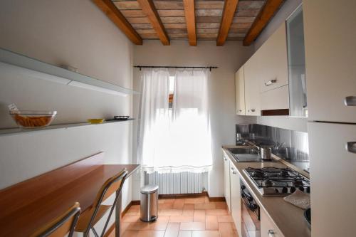 a kitchen with a counter top and a window at Cora Aparthotel Stradivari in CastellʼArquato