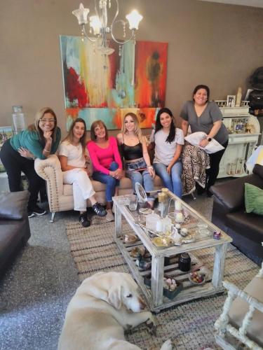 a group of women sitting in a living room with a dog at Mi Lugar en el Mundo in Buenos Aires