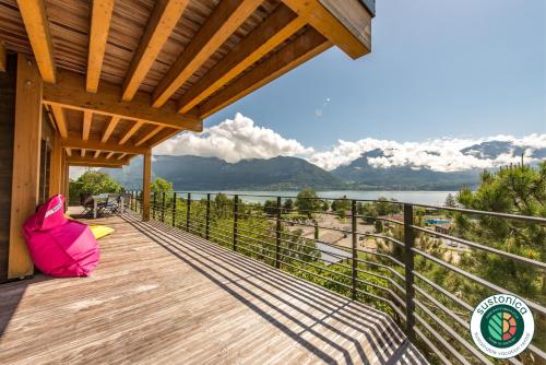 a wooden deck with a view of the water at Le Panoramic - Loft & Mainfloor Outstanding lake View - LLA Selections by Location lac Annecy in Sévrier