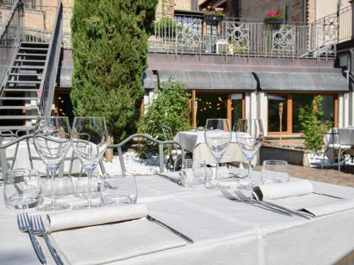 a table with wine glasses and napkins on it at Cora Hotels Leon d'Oro in CastellʼArquato