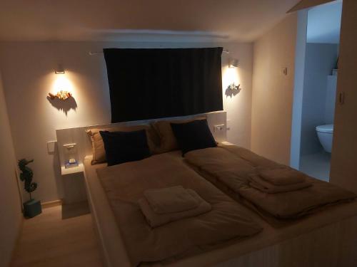 Una cama grande en una habitación con luces encendidas. en APARTMAN VINKO en Barbat na Rabu